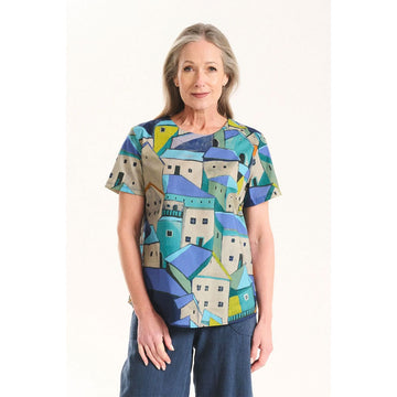 Colorful t-shirt with abstract village design on a white background.