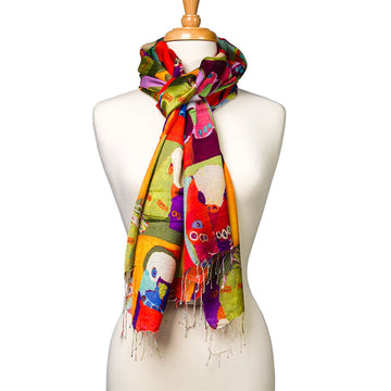A silk scarf printed with artwork by Karen Barnes is tied around the neck of a mannequin.
