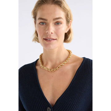 Gold chain necklace on a white background.