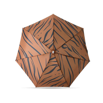 A folded up umbrella in a square pouch printed with tiger stripes.