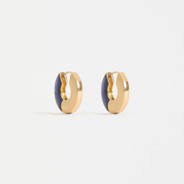 Pair of gold hoop earrings with blue centers on a white background