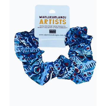 A cotton scrunchie printed with artwork by Murdie Nampijinpa Morris in blue and red.
