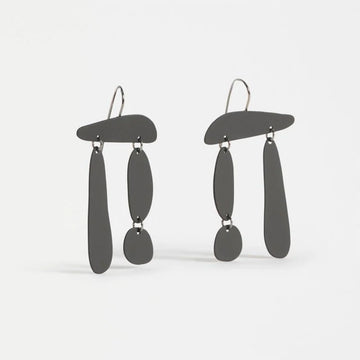 Pair of black earrings on a white background.