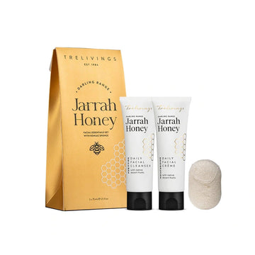 A gift set of two tubes and a sponge with a gold packet. Each item has the text 'Jarrah Honey' on it.