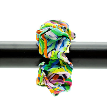 Colorful scrunchie on a black rod against a white background.