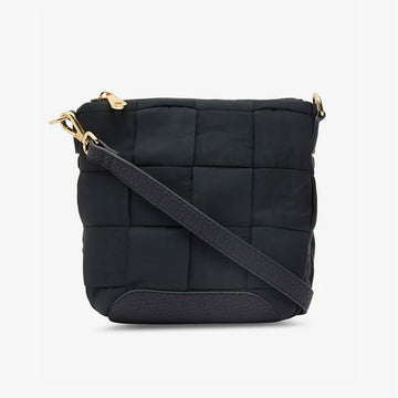 Front view of a cross body bag in black made up of a large woven design with a zip along the top and a black strap diagonally across the bag.