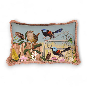 A rectangle cushion with fringe edges and illustrated with birds and flowers.
