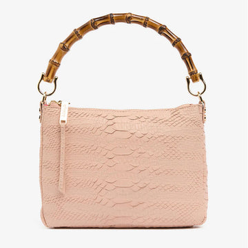 Front view of a bag with a top zipper and a blush snake texture with a round bamboo handle.