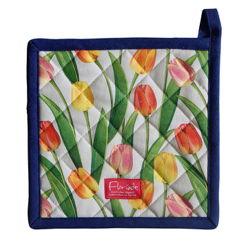 A fabric pot holder printed with tulips and a dark blue bias binding border.