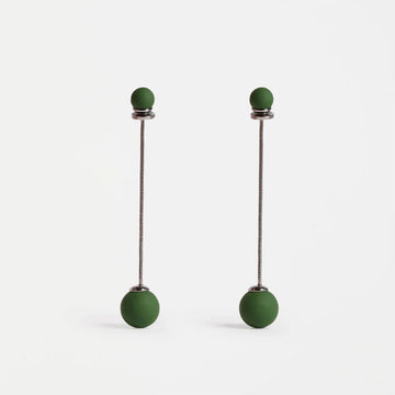 Pair of green drop earrings on a white background.