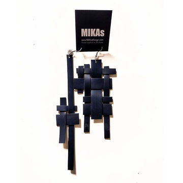 A pair of drop earrings featuring two different sized earrings made from black rubber in a hashtag shape.