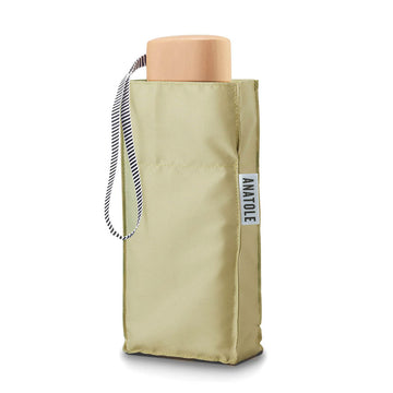 A folded up umbrella in light olive green in a square pouch.