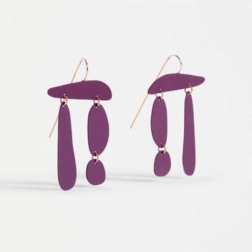 Pair of purple earrings on a light gray background.