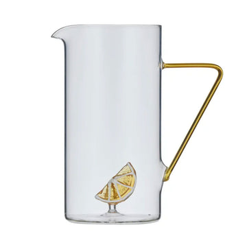 Clear glass pitcher with gold handle and lemon slice design on a white background.