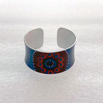 Cuff ring with a colorful design on a white background.