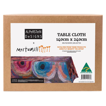 A brown box with a large label on the front with the heading 'Table Cloth' and a photo of the table cloth inside with artwork by Marianne Burton.