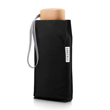 A black folded up umbrella in a square shaped pouch.