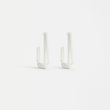 Pair of silver hoop earrings on a white background.