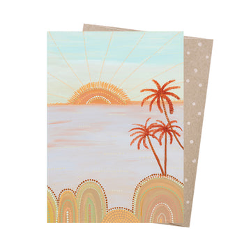Card with a beach scene featuring palm trees and a sun, with a polka dot envelope.