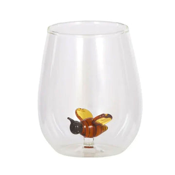 Clear glass with a bee decoration on a white background.