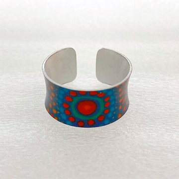 Silver cuff ring with a colorful circular design on a white background.