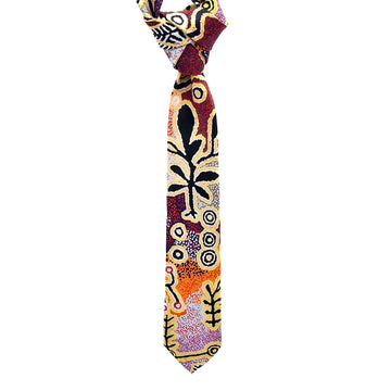 A tie printed with artwork by Paddy Stewart with black symbols over a orange and burgundy background.