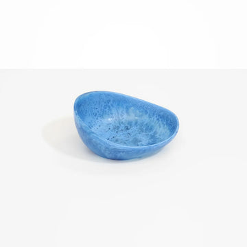 A small desert bowl made from blue resin.