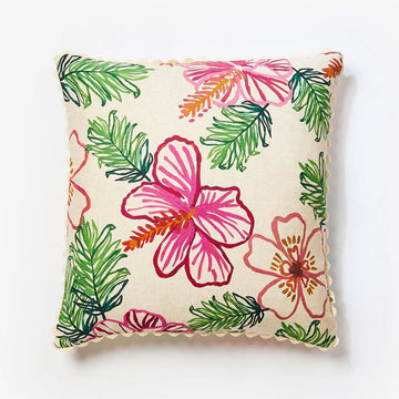 A square cushion printed with line drawings of pink flowers and green leaves.