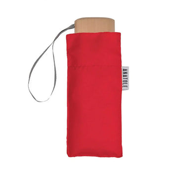 A folded up red umbrella in a square shaped pouch.