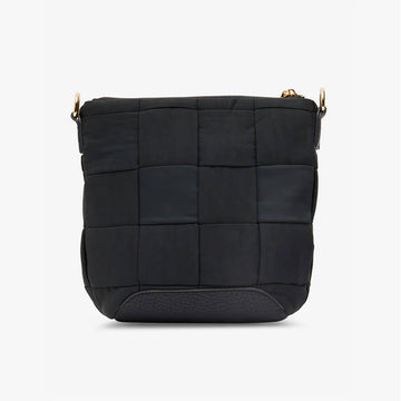 Front view of a cross body bag in black made up of a large woven design with a zip along the top and a black strap diagonally across the bag.