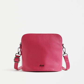 Front view of a cross body bag in hot pink with matching detachable straps and the ELK logo visible.