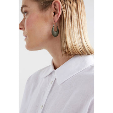 A pair of hoop shaped earrings with a wide dark green base.