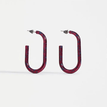 Red hoop earrings on a white background.