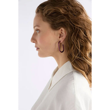 Pair of black hoop earrings with blue speckles on a white background.