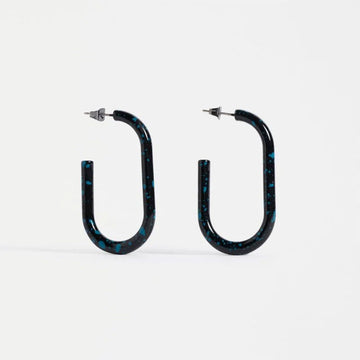 Pair of black hoop earrings with blue speckles on a white background.