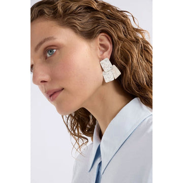 Pair of silver square earrings on a light gray background.