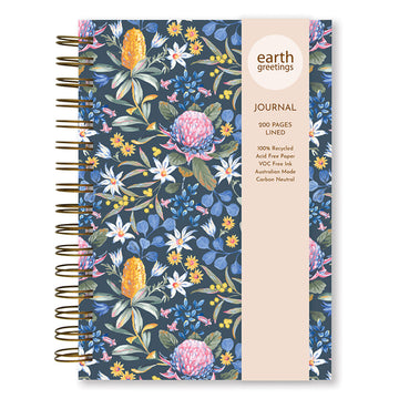 Front cover of a journal illustrated with flowers on a dark blue background and a product information sleeve over the top.