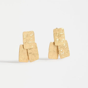 Pair of gold earrings on a white background.