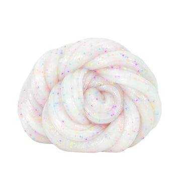 A round silver tin inside a green packet with the heading 'Crazy Aarons Glowbrights'. There white glittery putty behind the packet.