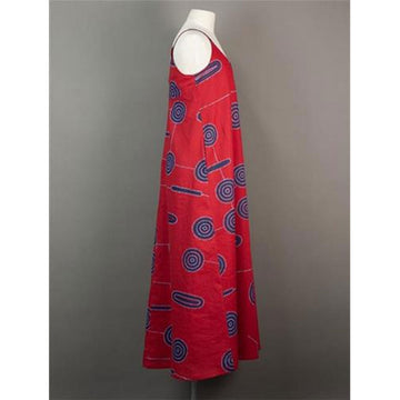 Front view of a red dress with blue circular patterns on a mannequin against a gray background.