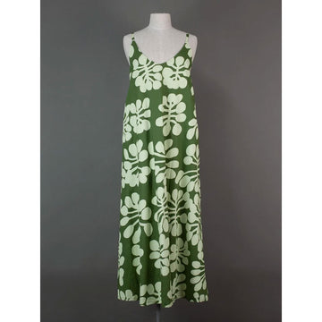 Green dress with white floral pattern on a mannequin against a gray background.
