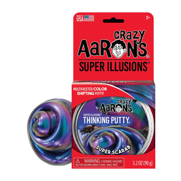 A round silver tin inside a red packet titled 'Crazy Aarons Super Illusions' with purple swirled putty behind the packet.