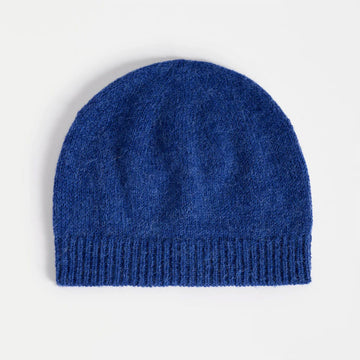 Blue knit beanie on a light gray background.