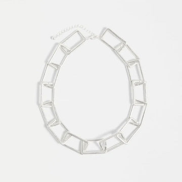 A silver chunky chain necklace on a white background.