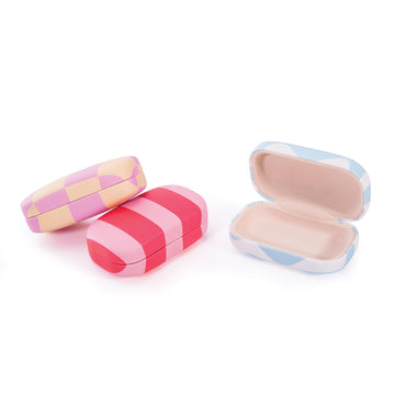 Three hard shell cases each with a different pattern and colour printed on them.