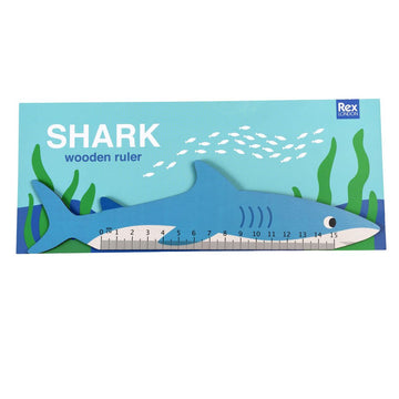 A ruler shaped as a shark in blue and white in packaging depicting a sea