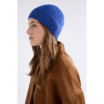 Blue knit beanie on a light gray background.