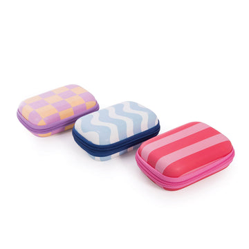 Three hard shell travel cases pictured with zip closures and each printed with a different pattern and colour.