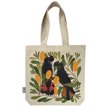 A calico tote bag printed with an illustration of two black cockatoos and banksia flowers.