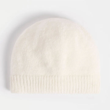 White knit beanie on a light gray background.
